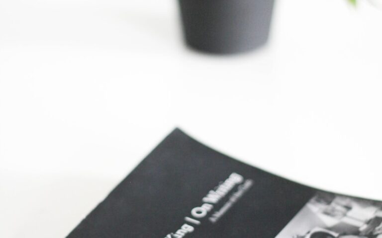 black and white book beside green potted plant