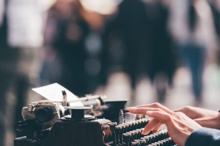 person using black typewriter