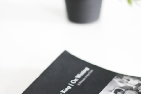 black and white book beside green potted plant