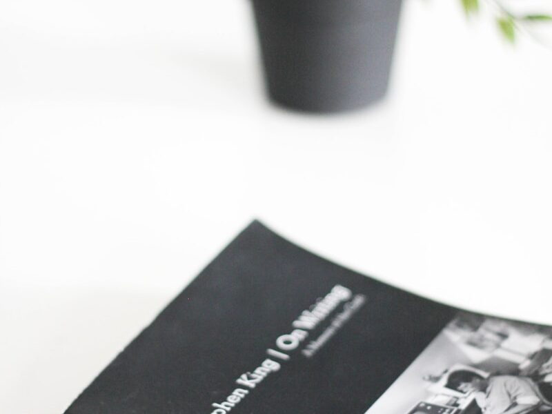 black and white book beside green potted plant