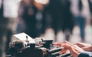 person using black typewriter