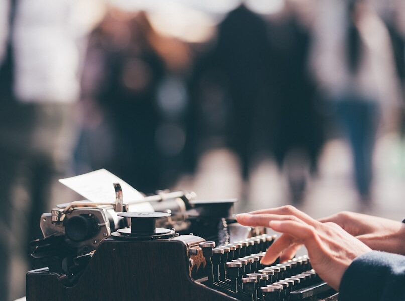 person using black typewriter